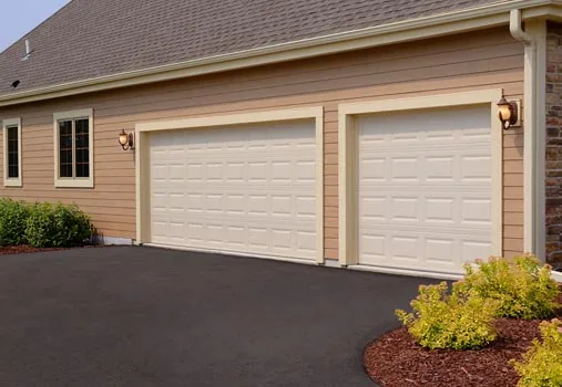 Two beige raised-panel residential garage doors