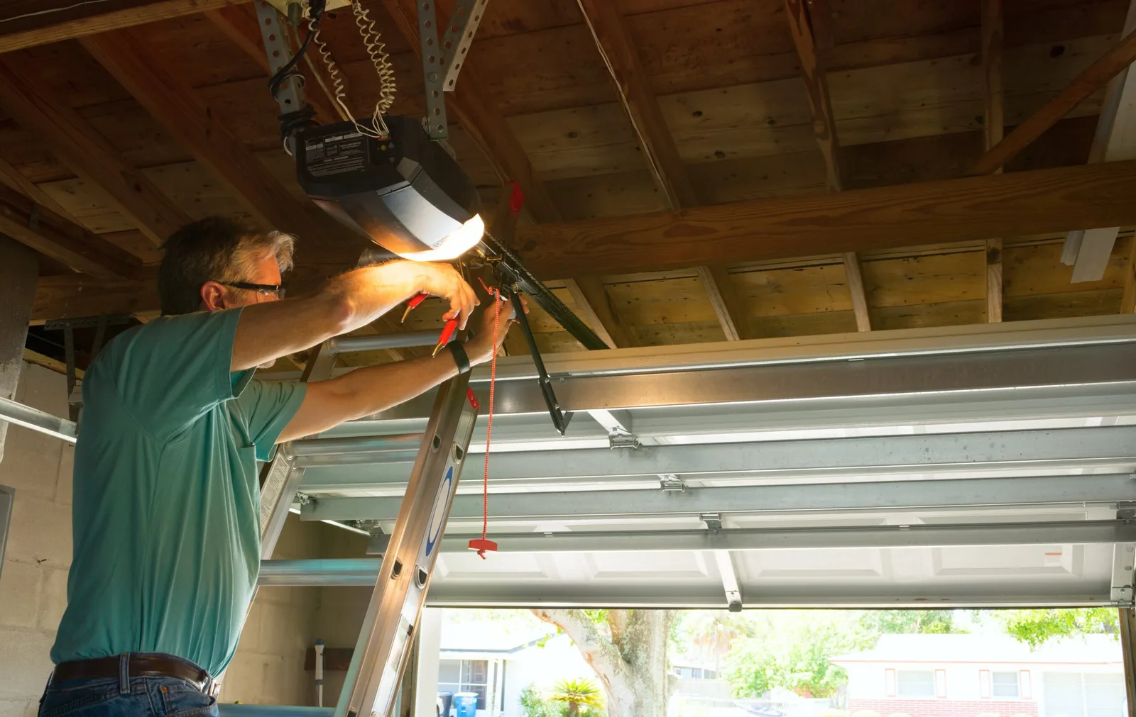 A&E technician servicing a garage door opener