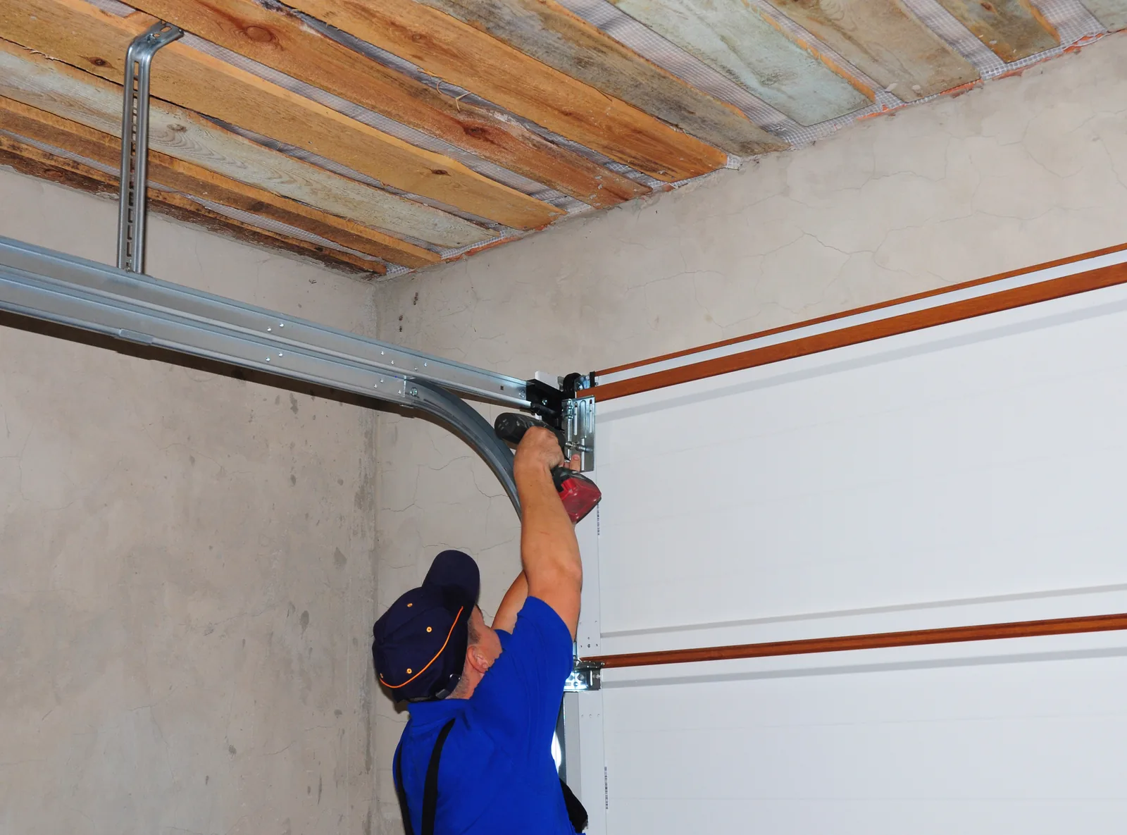 A&E technician installing a garage door opener rail